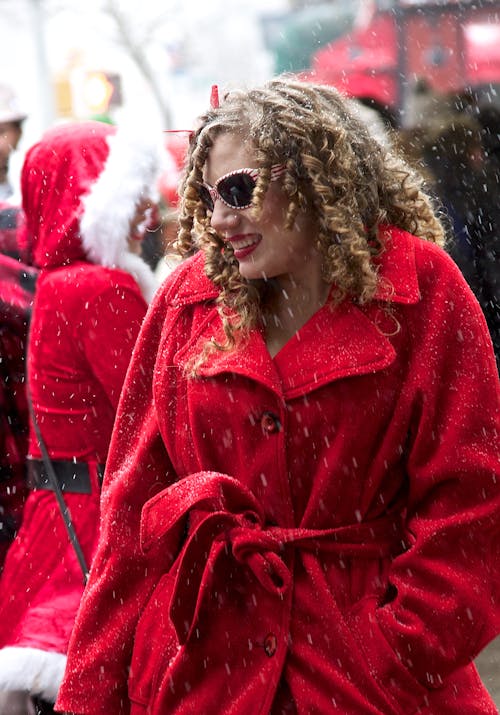 Woman in Red Coat Wearing Sunglasses
