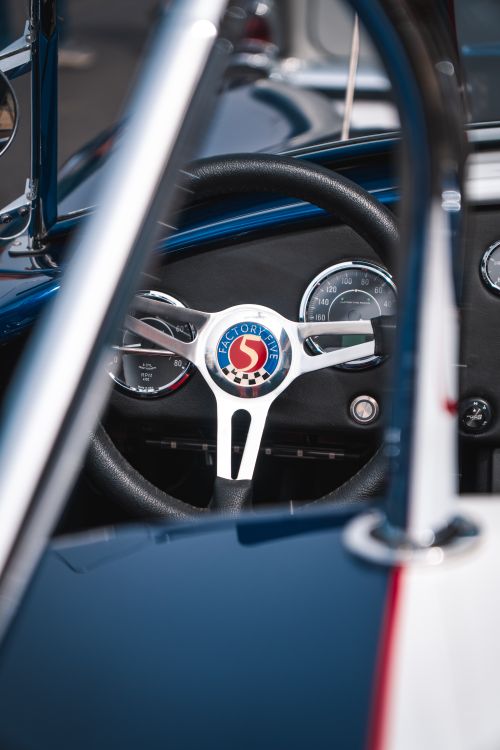 Free Classic Shelby Cobra dashboard with chrome details and steering wheel view. Stock Photo