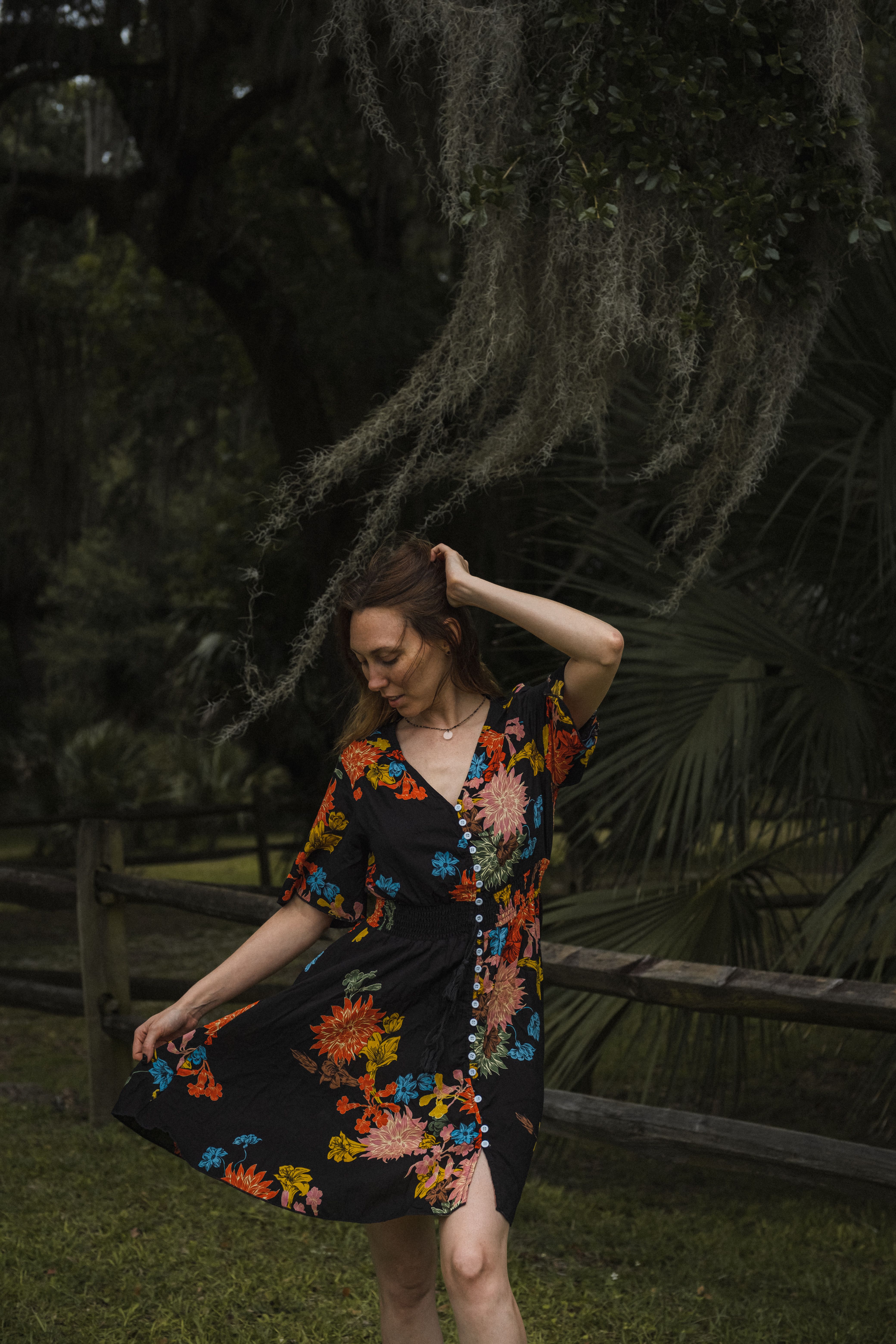 A Woman in Black Dress with Floral Design · Free Stock Photo