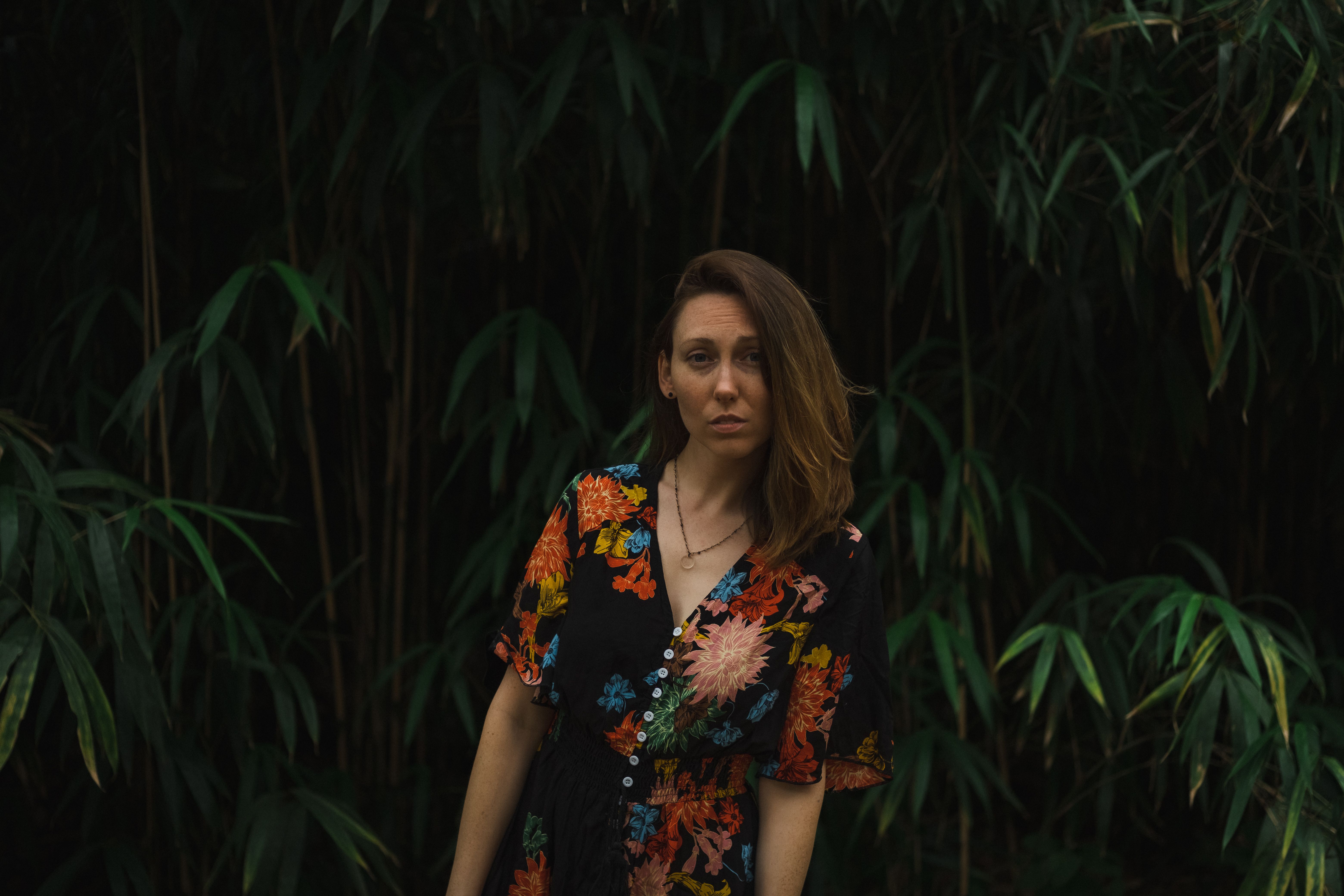 A Woman in Black Dress with Floral Prints · Free Stock Photo