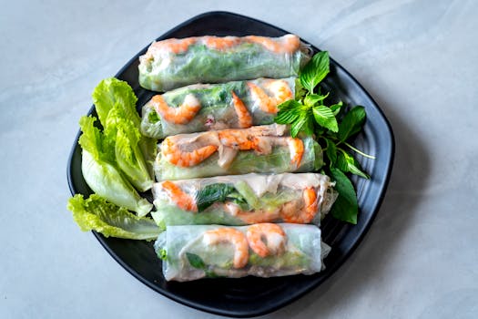Close-up of authentic Vietnamese spring rolls filled with shrimp and vegetables on a plate.