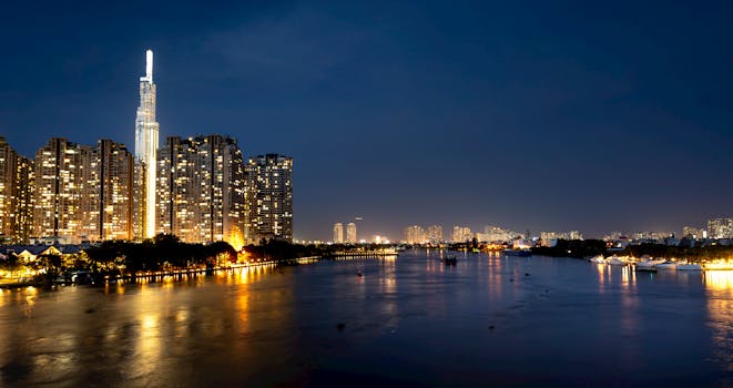 Beautiful cityscape view of a skyline and river illuminated at night.