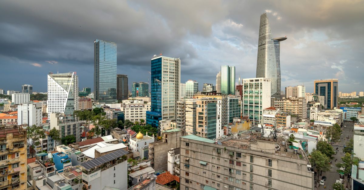 Ho Chi Minh City's skyline with modern skyscrapers against an overcast sky, captured in a stunning aerial view.