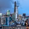 A panoramic view of the modern Ho Chi Minh City skyline with illuminated skyscrapers at dusk.