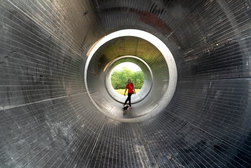 Person with Dog in Metal Tunnel