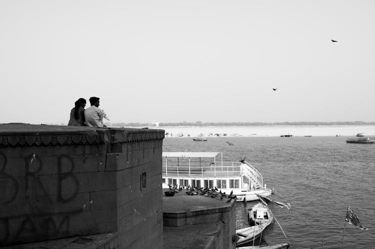 Man And Woman Looking At Sea And Horizon