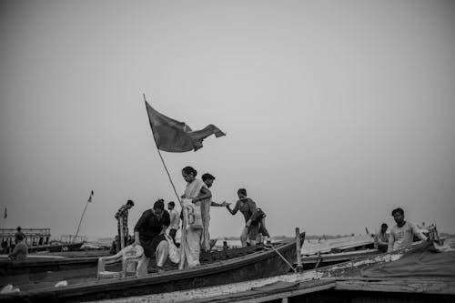 Grayscale Photo of People on a Boat