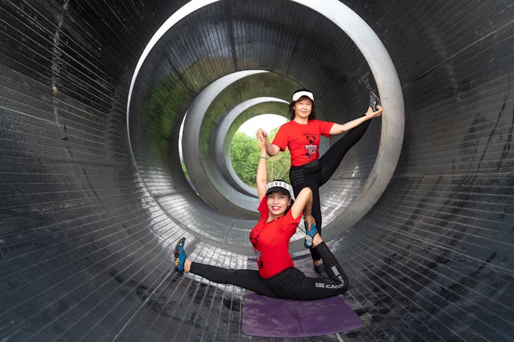 Flexible Girls Exercising In Tunnel