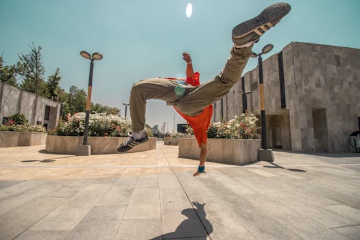 Captivating street dance midair flip by a dynamic performer in an urban setting.