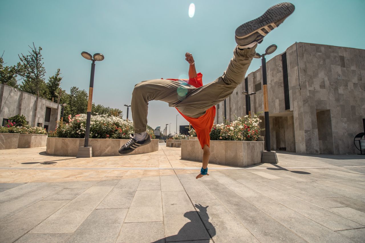 captivating street dance midair flip by a dynamic performer in an urba