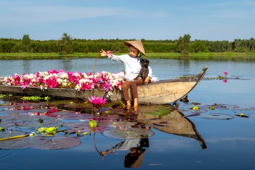 Cute Girl in a Boat Full of Flowers