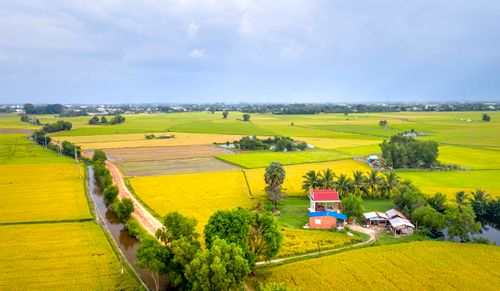 Free Breathtaking aerial view of farmland and rural houses on a cloudy day. Stock Photo