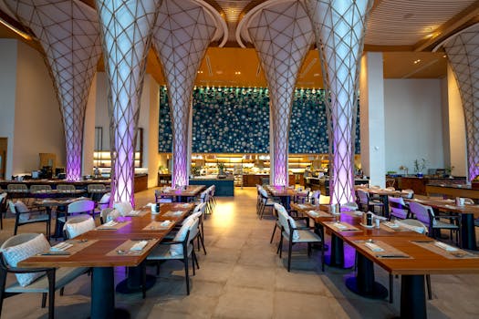 Spacious modern restaurant interior with unique illuminated columns and elegant decor.