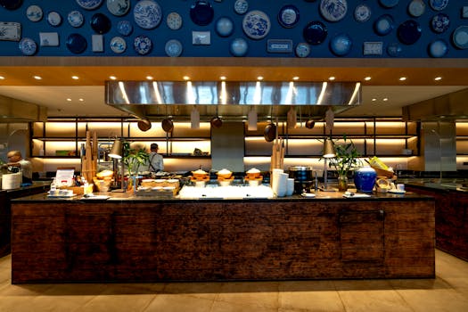 Modern restaurant kitchen with vibrant wall decor and wooden countertops.