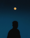 Silhouette of Man Under Full Moon