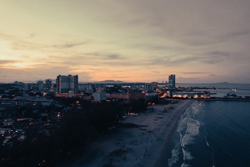 Aerial View of City Over the Ocean at Dusk