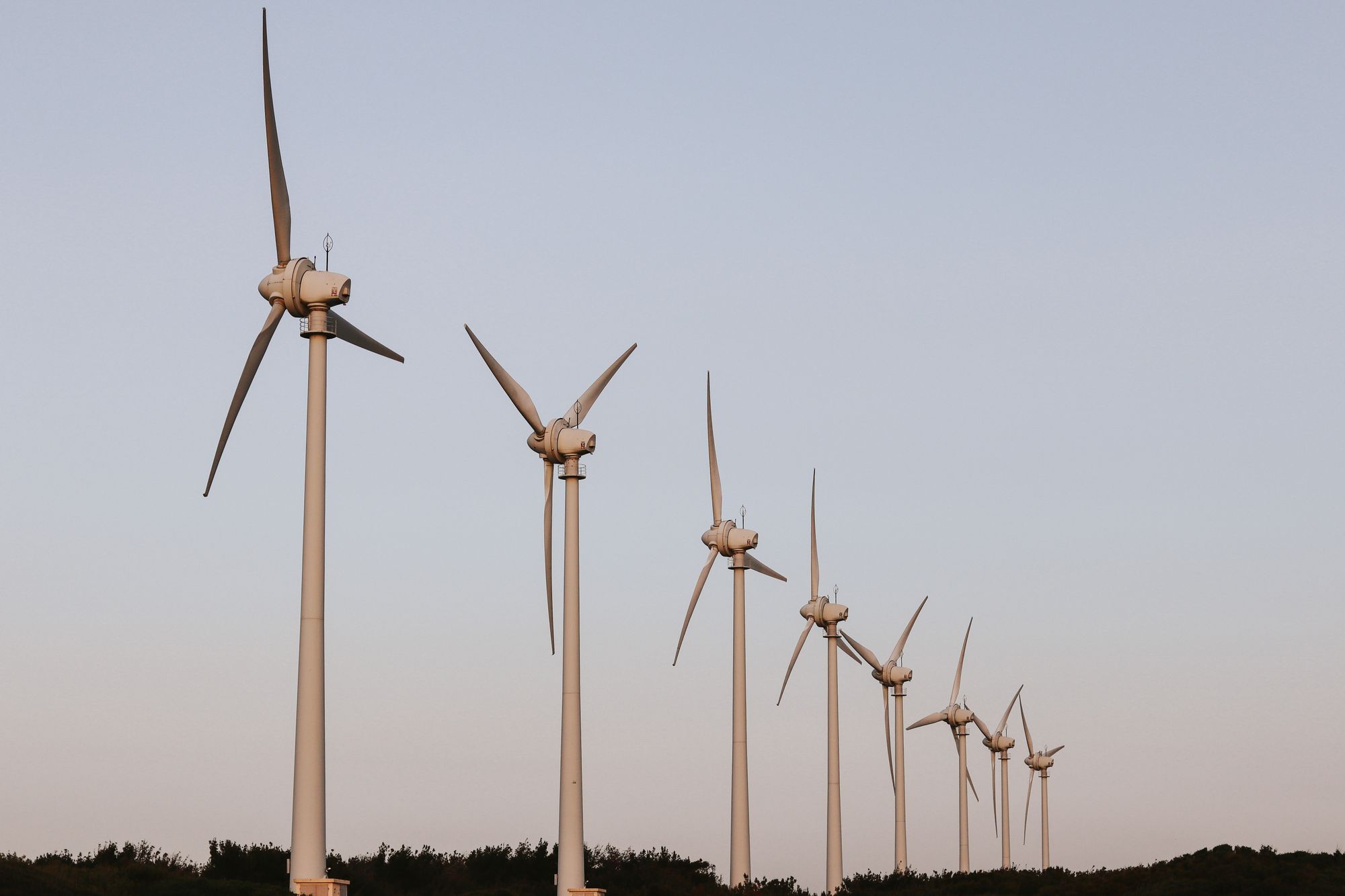 Wind turbines standing against a clear open sky