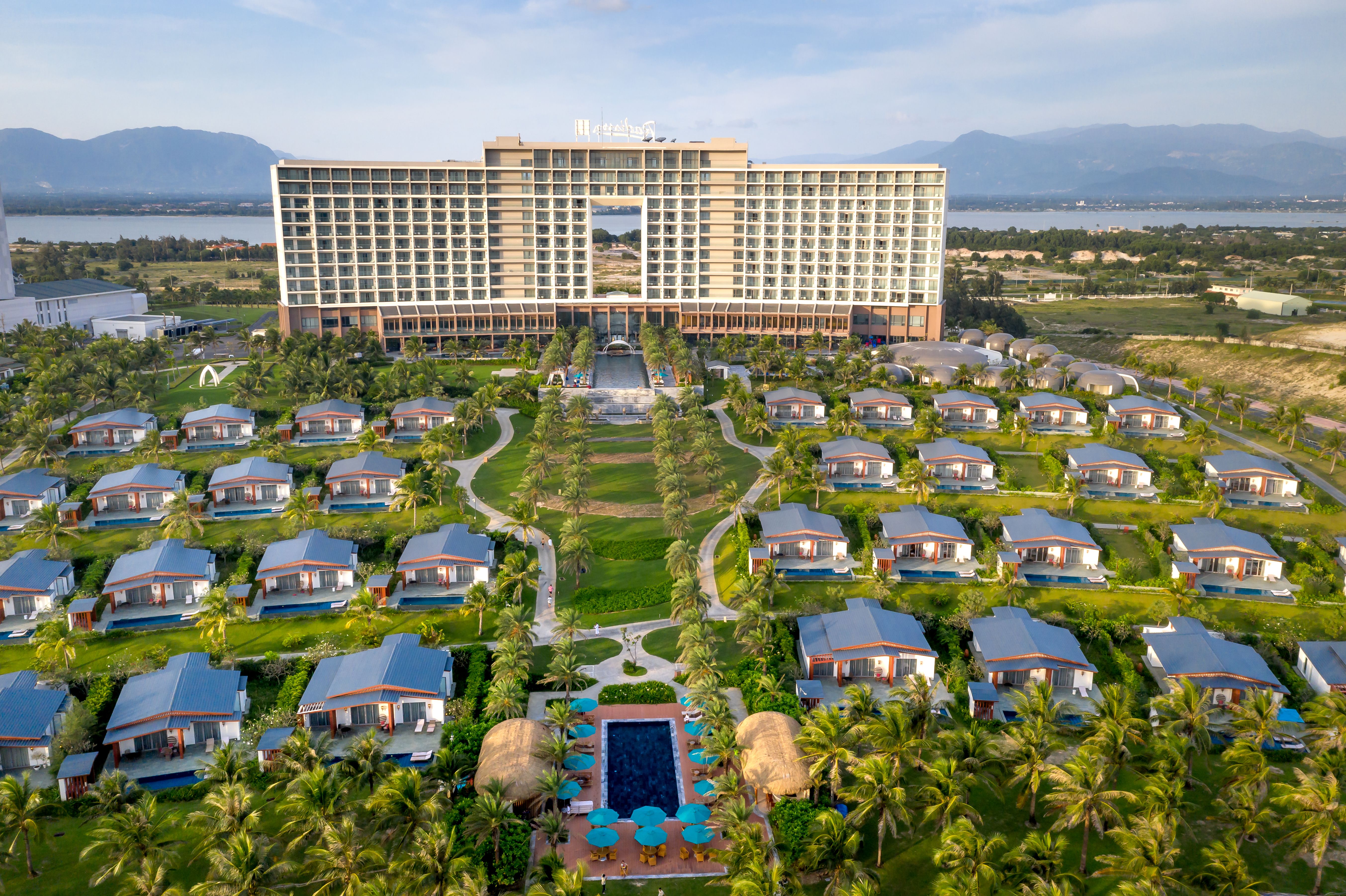 Aerial view of a luxury resort with villas and mountains