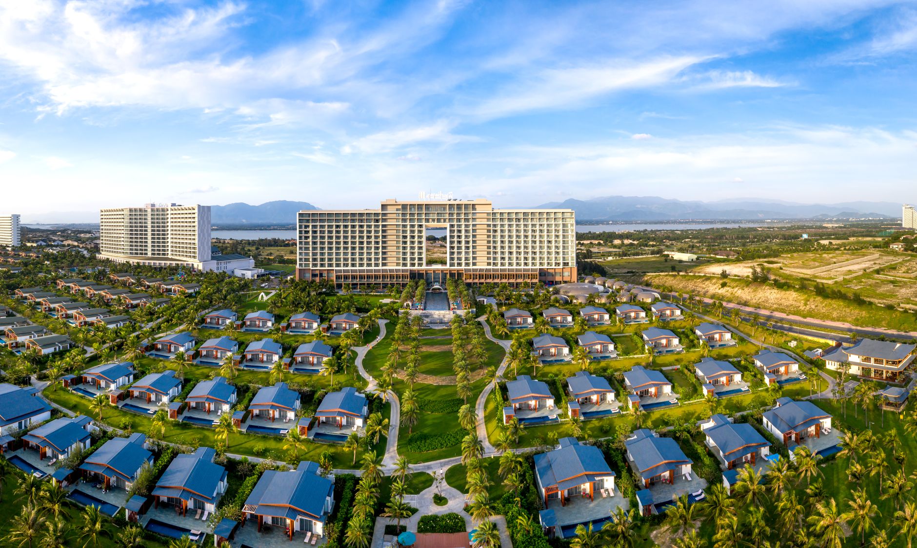 Aerial sunrise view of a pristine luxury golf course representing the strategic equilibrium of curated sporting excellence.