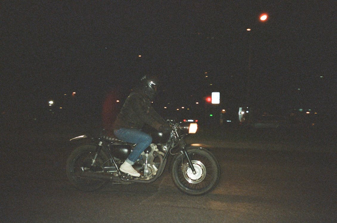 Person Riding on Motorcycle on Road during Nighttime