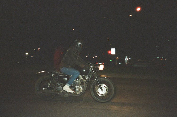 Person Riding On Motorcycle On Road During Nighttime