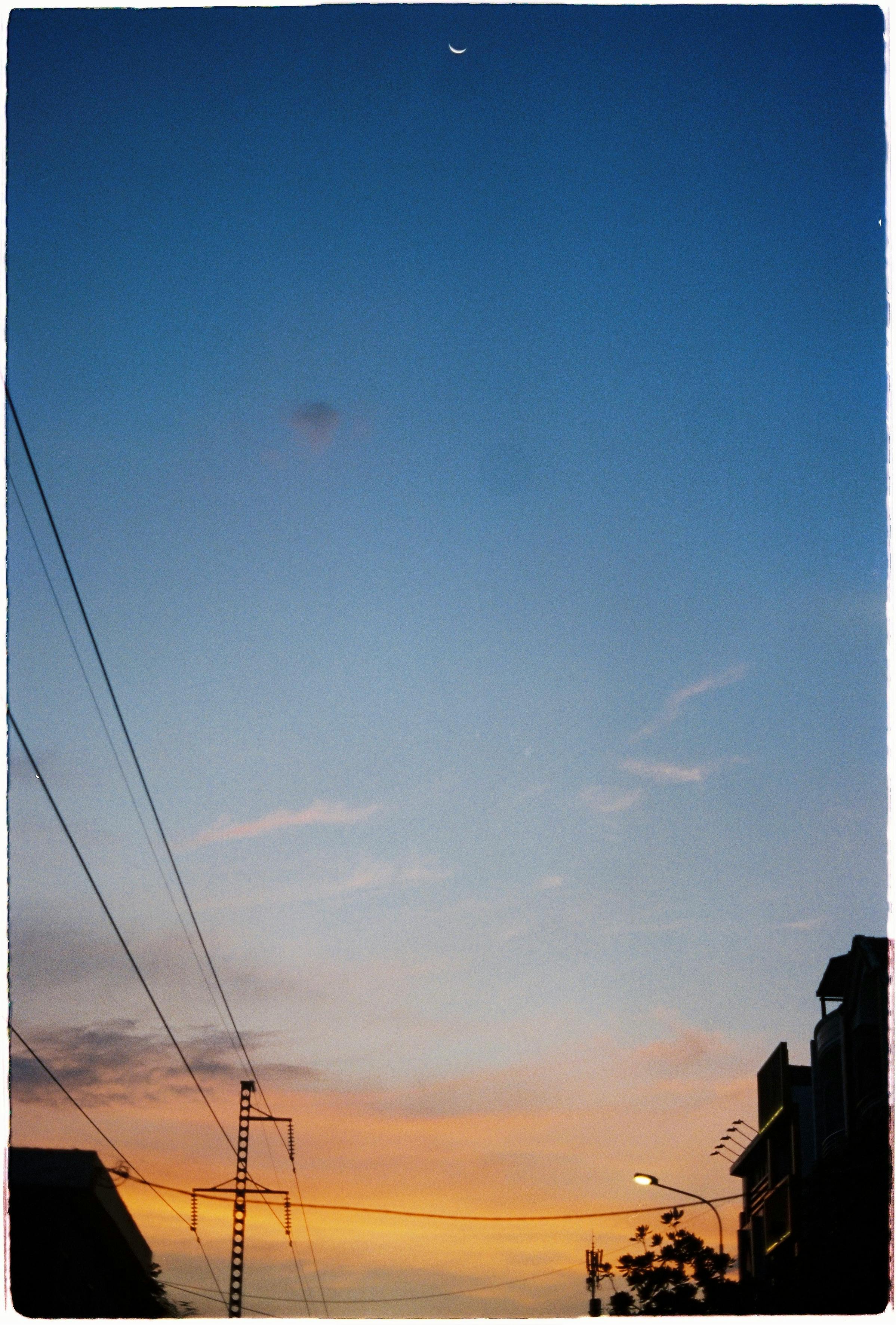 Captivating skyline at sunset with buildings in silhouette against a colorful sky.
