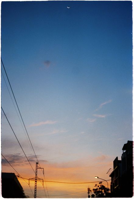 Captivating skyline at sunset with buildings in silhouette against a colorful sky.