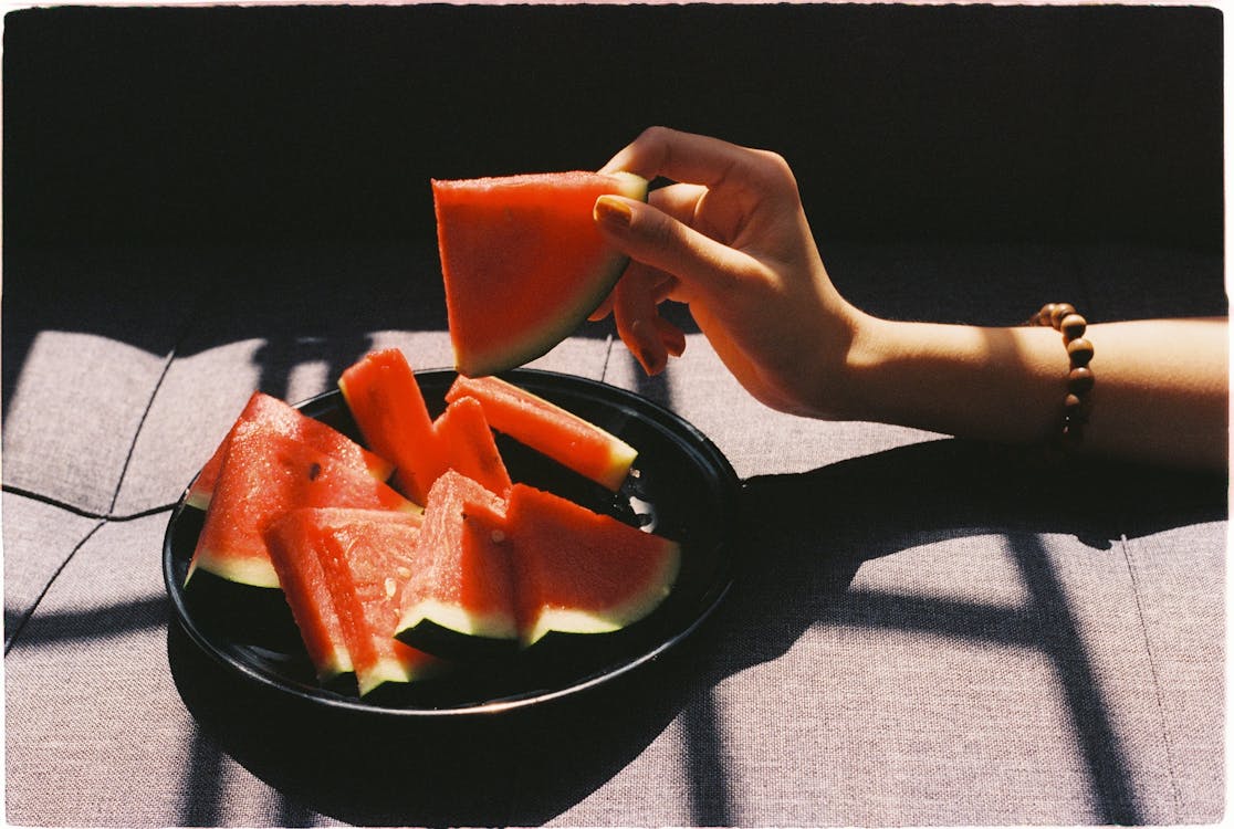 Free Person picking sliced Watermelon Fruit Stock Photo