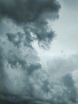 A captivating view of dark storm clouds in the sky, creating a dramatic and moody atmosphere.. captivating, view, dark