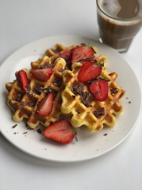 Close-up of Waffles and Strawberries on White Plate
