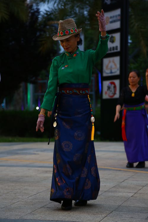 Elderly Woman in Traditional Wear doing a Graceful Dance