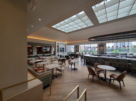 Spacious and elegant hotel bar with modern decor and open seating in Irving.