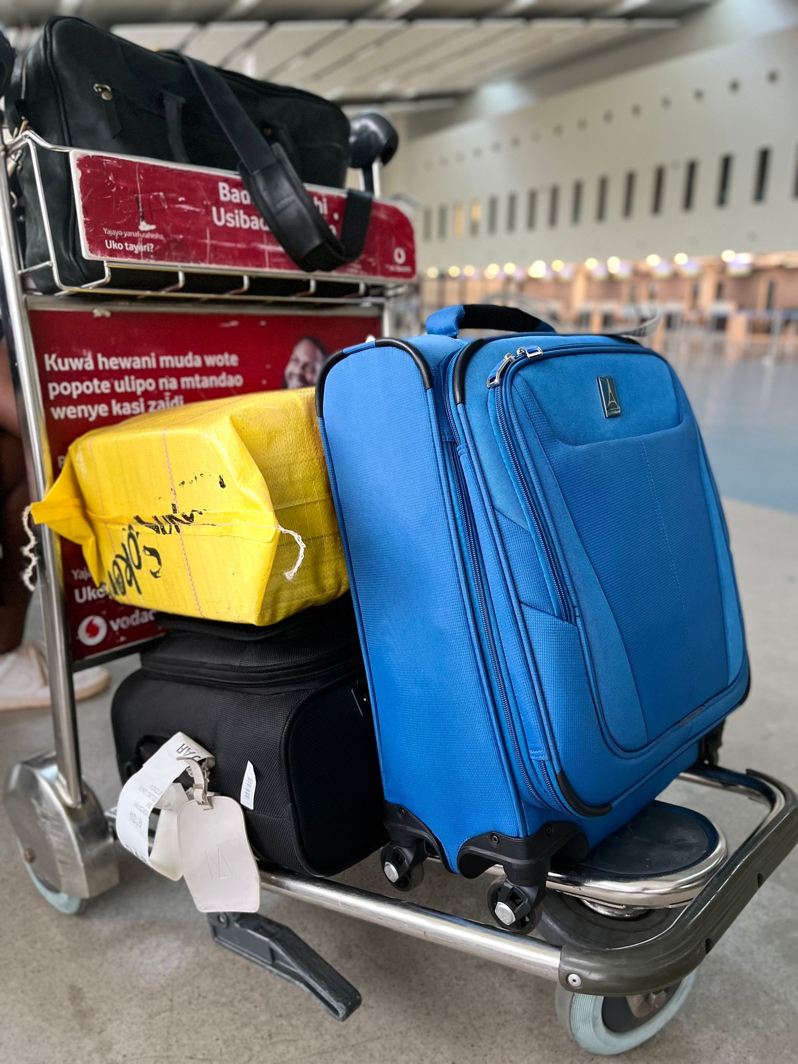 Luggage stacked on a trolley at an airport