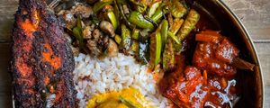 Rice meal with fried fish and curries