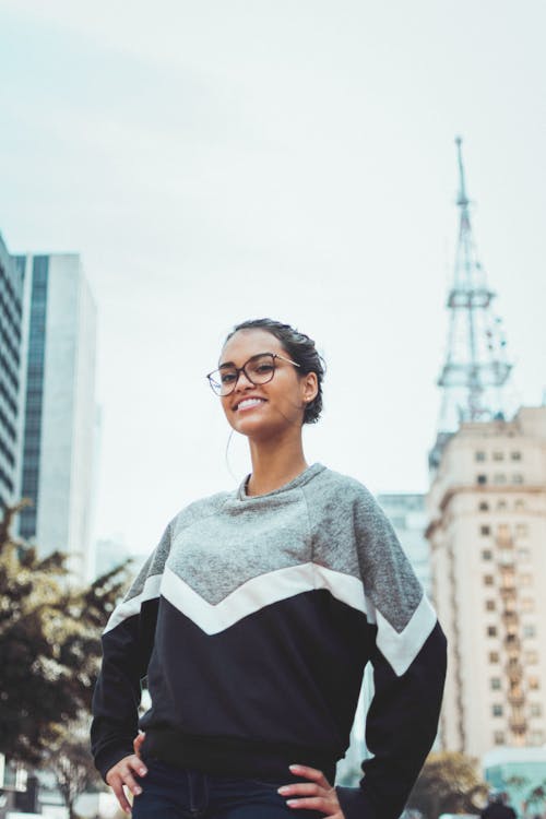 Woman Wearing Black and Gray Crew-neck Sweater Near Building at Daytime