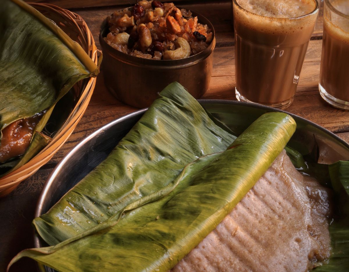 South Indian breakfast served on a banana leaf with tea