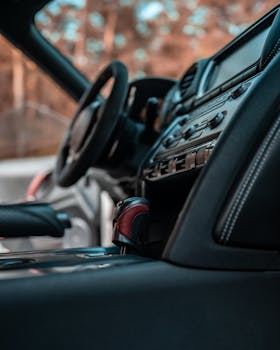 Detailed view of a luxury car's interior featuring a sleek dashboard and comfortable seating.