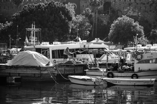 Grayscale Photo of Docked Boats