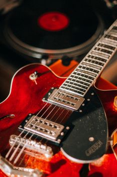 Detailed image of an electric guitar fretboard with focus on the strings and body.