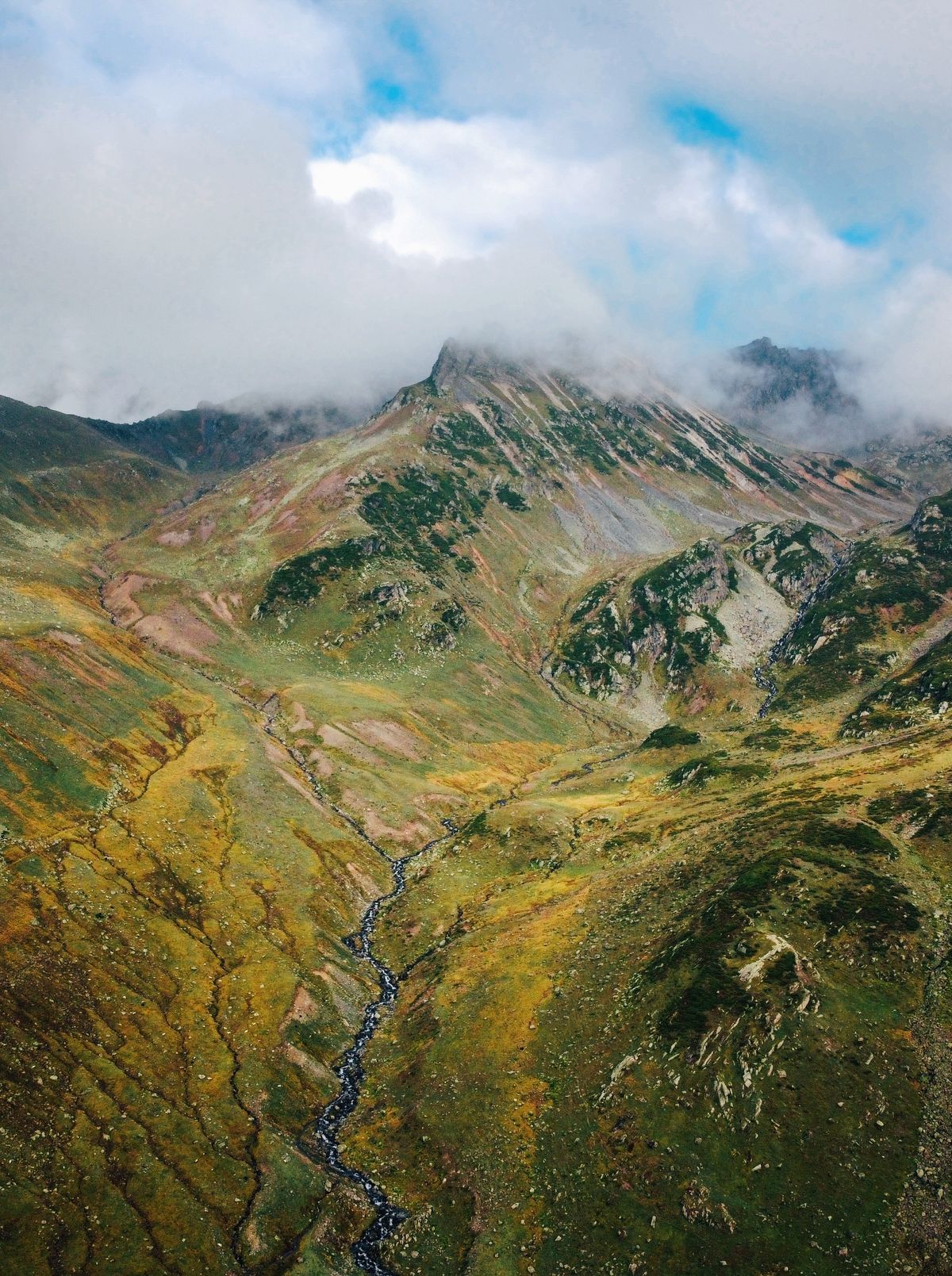 Green valley framed by steep mountain slopes