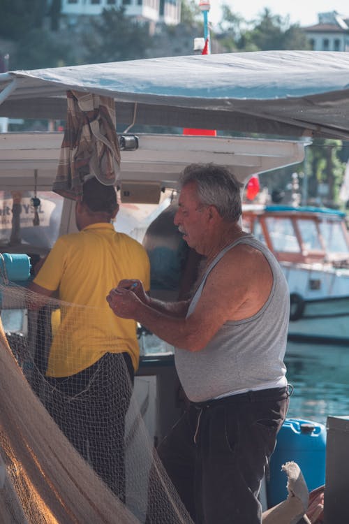 adam, balık ağı, balıkçı içeren Ücretsiz stok fotoğraf