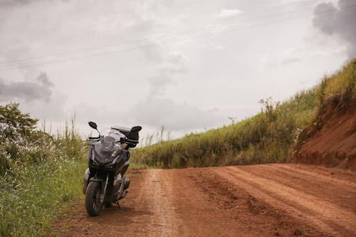 Black Motorcycle on Brown Dirt Road