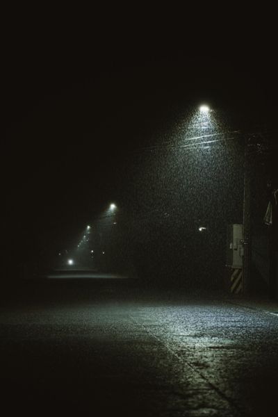 Rain falling on an empty street at night — photo by Denniz Futalan on Pexels