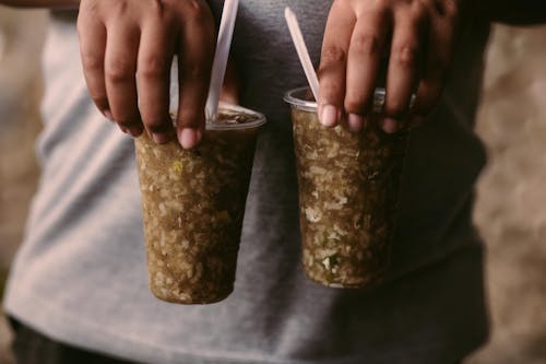 Hands Holding Cups with Drinks