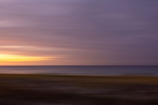 Peaceful sunset view over the Baltic Sea at Graal-Müritz, Germany, with calm waters and dramatic sky.