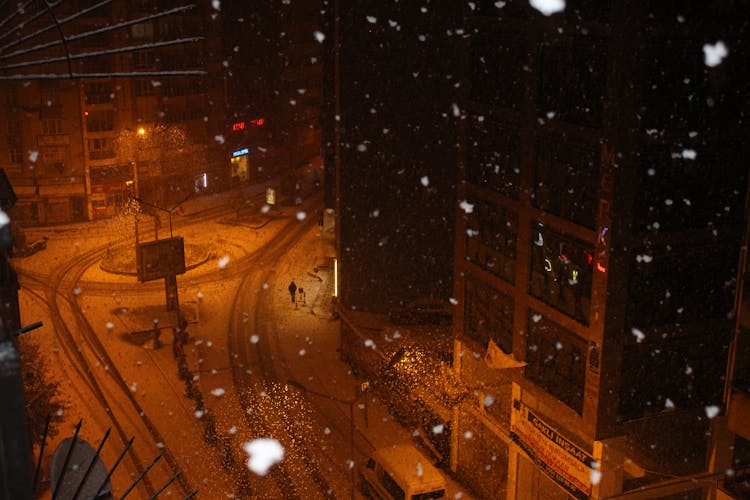 Aerial Photography Of A Person Walking On The Street During Snowfall