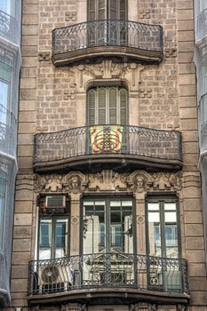 Detailed view of an ornate building facade featuring decorative balconies and stonework.