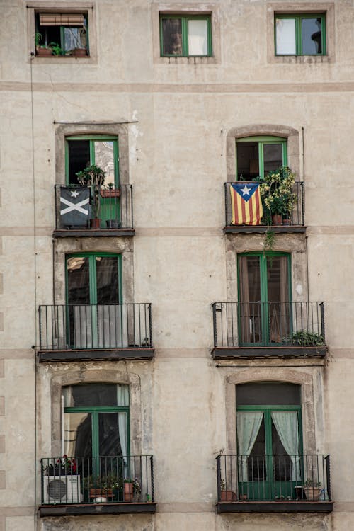 Free Gray Concrete Building With Glass Windows and Balconies Stock Photo