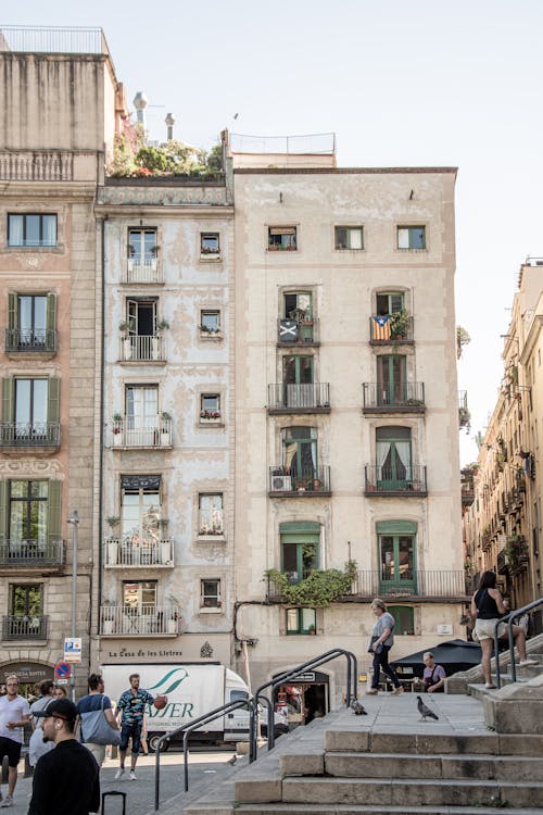 People Walking near a Concrete Building