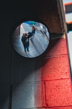 Innovative street photography capturing creative reflection in an urban setting.